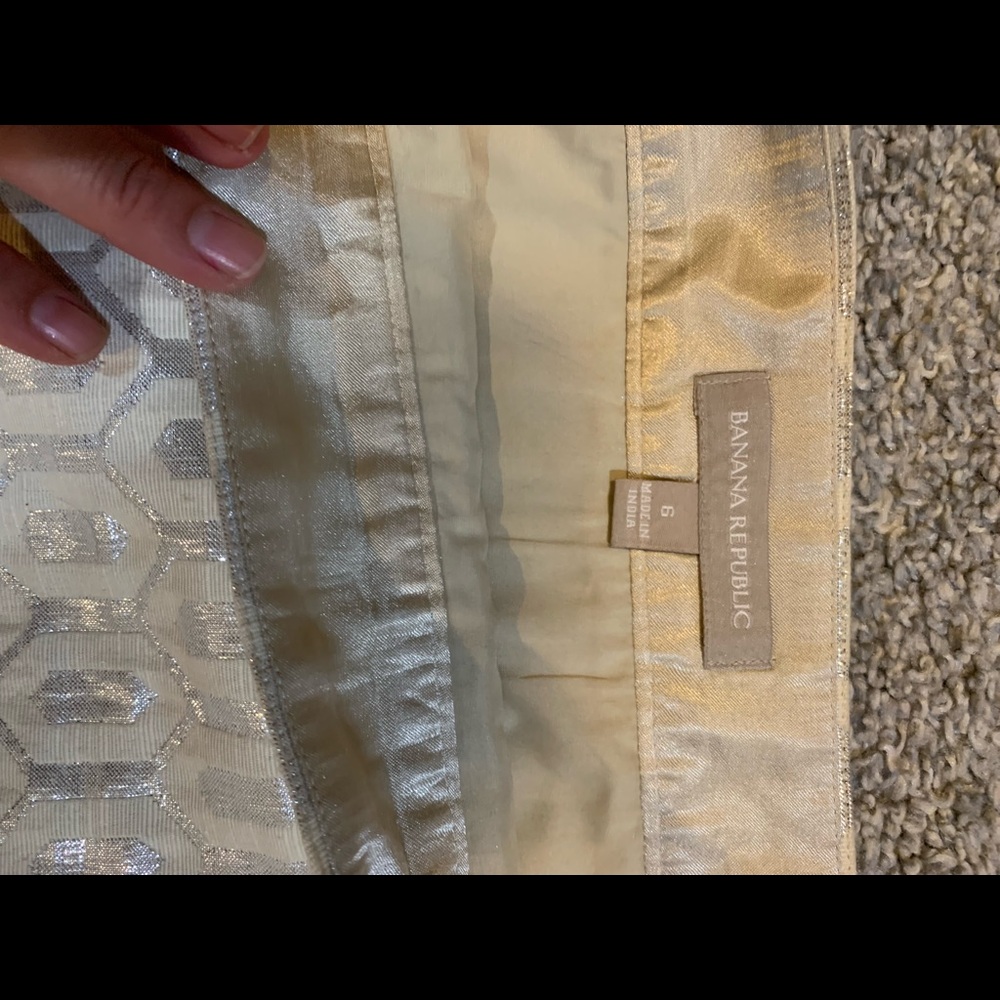 Cream colored skirt with silver shimmery detailing.